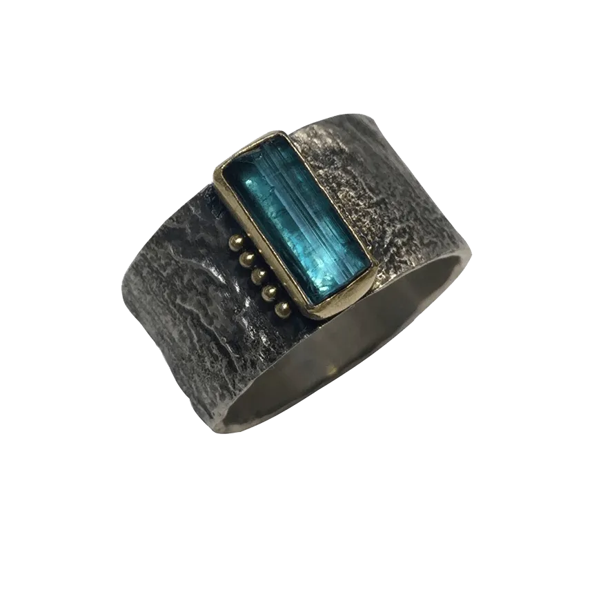 blue tourmaline crystal in gold on erosion band