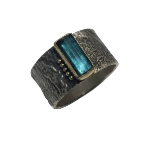 blue tourmaline crystal in gold on erosion band